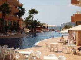 chairs an tables round a pool