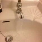 half of sink in shot with tap and plug