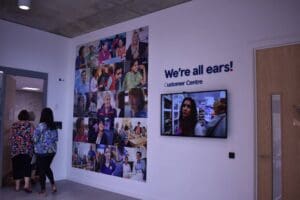 Tesco room pictures on wall of people and "we're all ears"