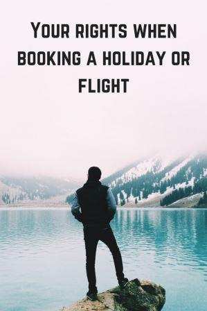Man standing on rock looking out to water your rights when booking a holidays or flights