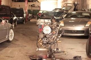 Engine in garage with cars