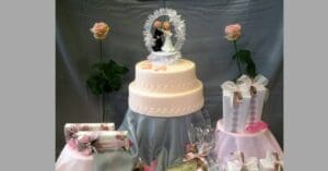 wedding cake groom and bride with white frill round them flower either side