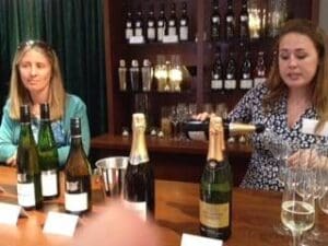 Bar two women serving sparkling wines