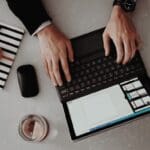 two hand on laptop on desk