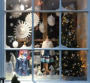Christmas scene behind window children's clothes