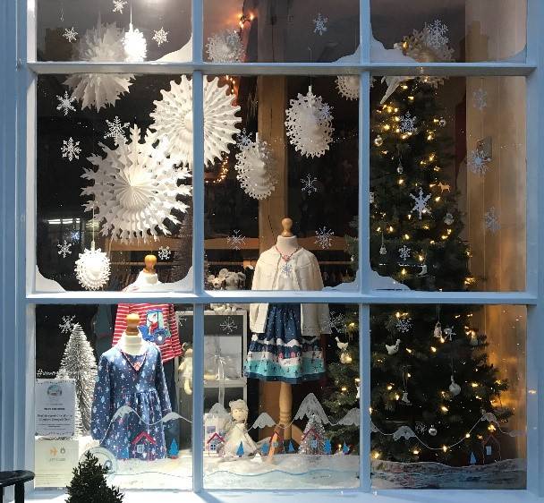 Christmas scene behind window children's clothes