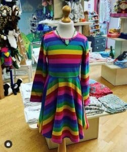 multi coloured dress in a shop on a mannequin 