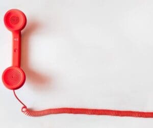 old fashioned red phone and cord hand piece with long cord