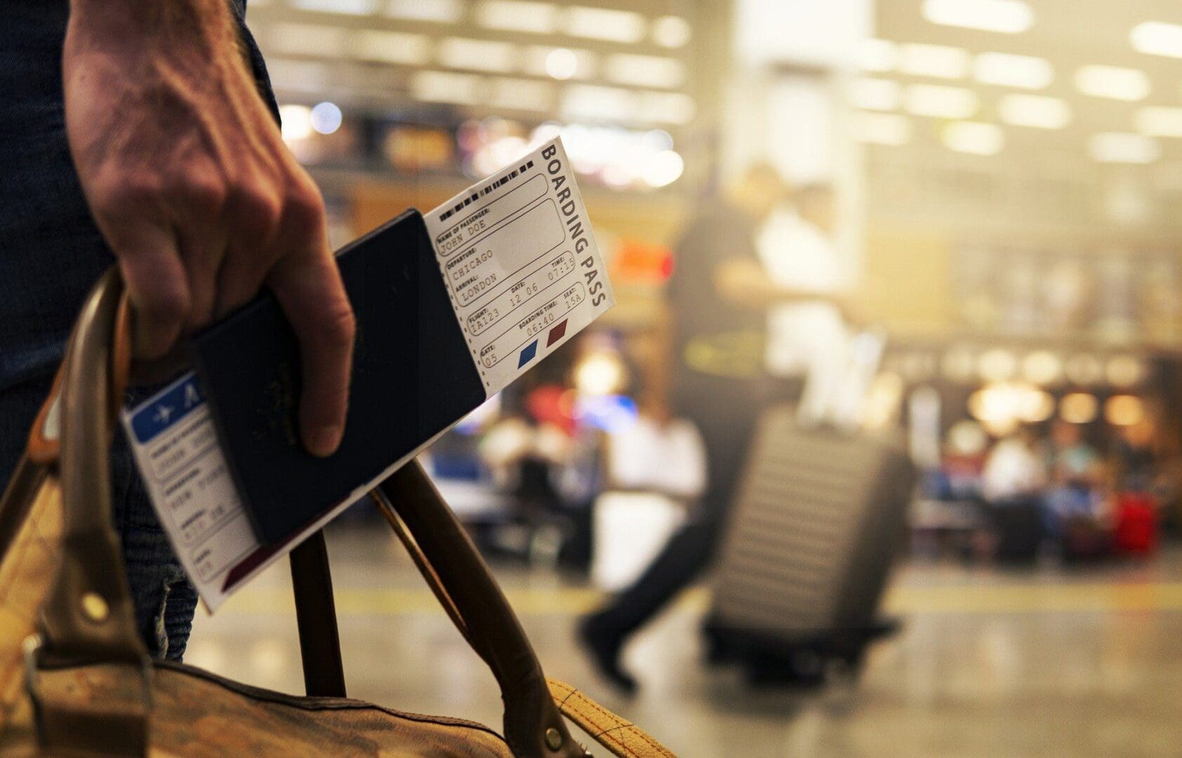 hand holding boarding pass in airport
