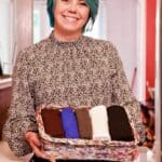 Janine with wicker basket of towels folded up