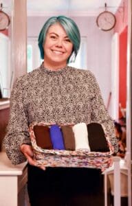 Janine with wicker basket of towels folded up