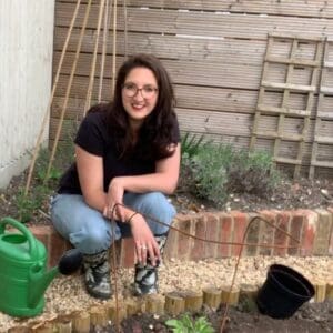 Kendall in the garden smiling about to dig