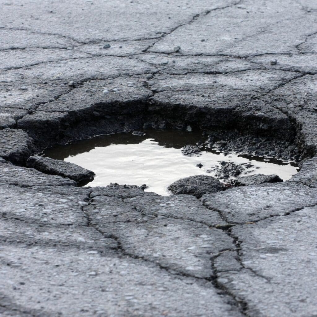 Large pot hole with water in it