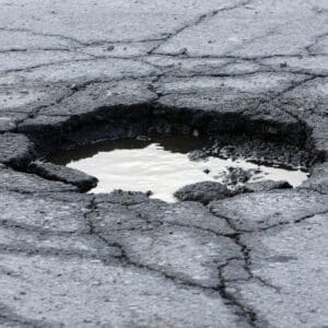 pot hole with water in it how to complain