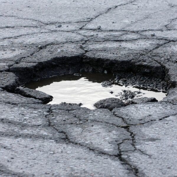 Large pot hole with water in it