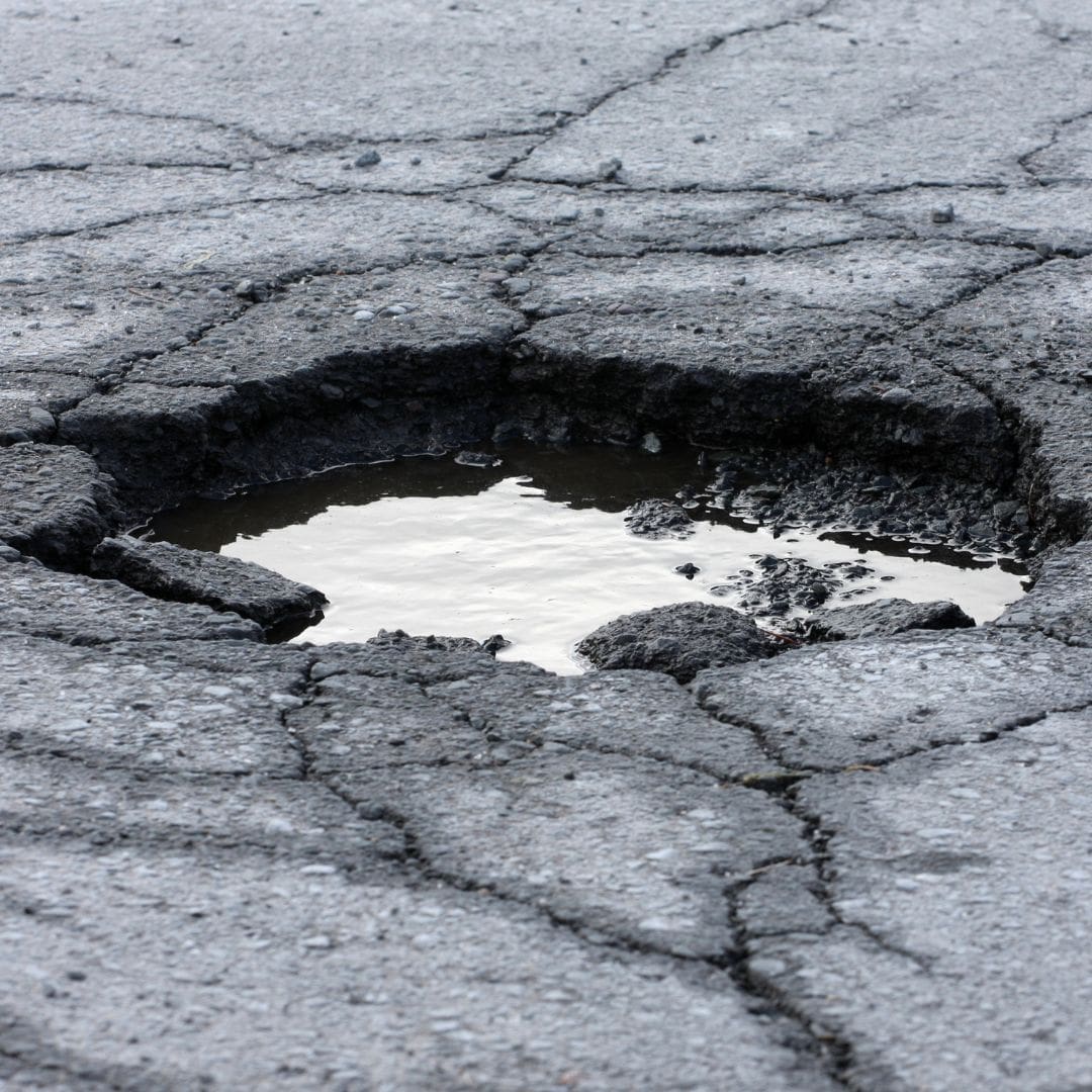 Large pot hole with water in it