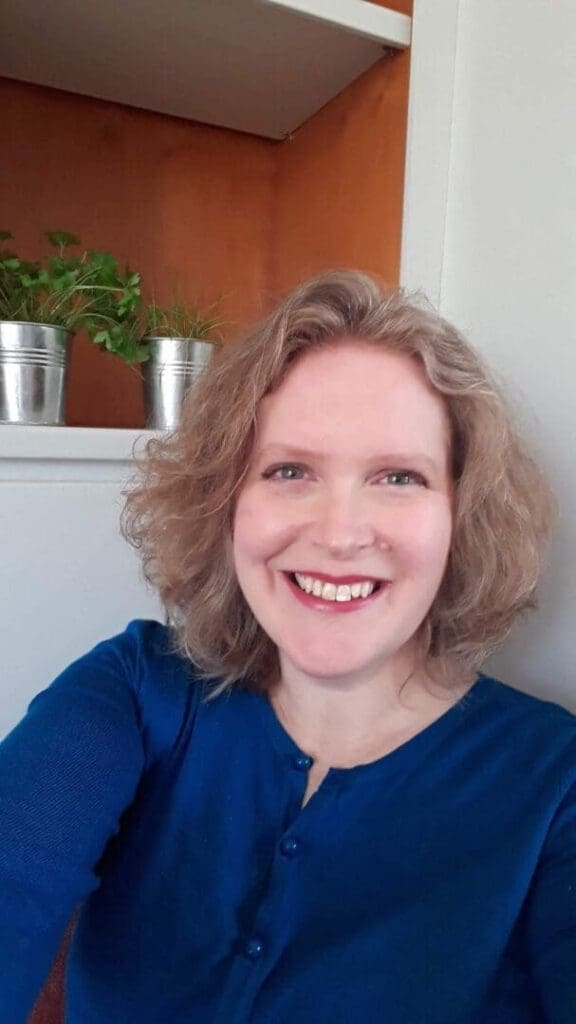 Short wavy light brown hair head and shoulders blue top