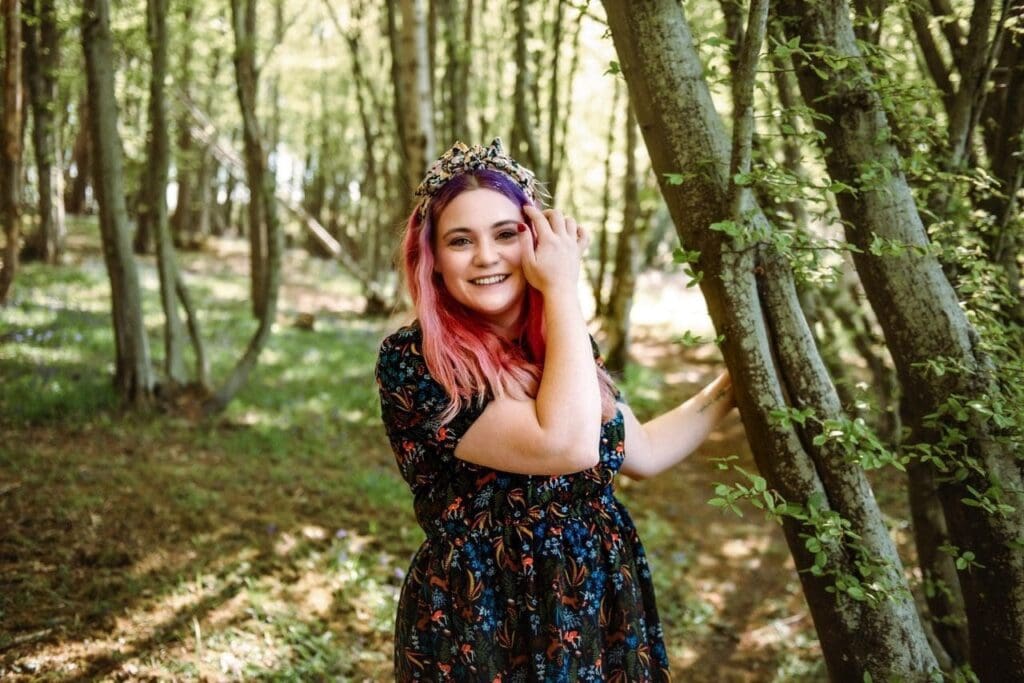 Bex Spiller anti burnout expert standing next to tree in a forest
