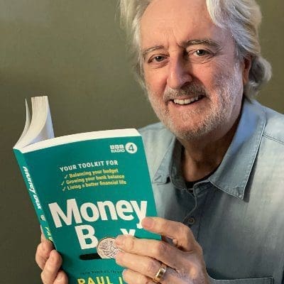 Man with grey hair reading MoneyBoc book
