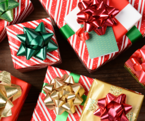 selection of boxes wrapped in red and white striped paper with green/red/gold bows