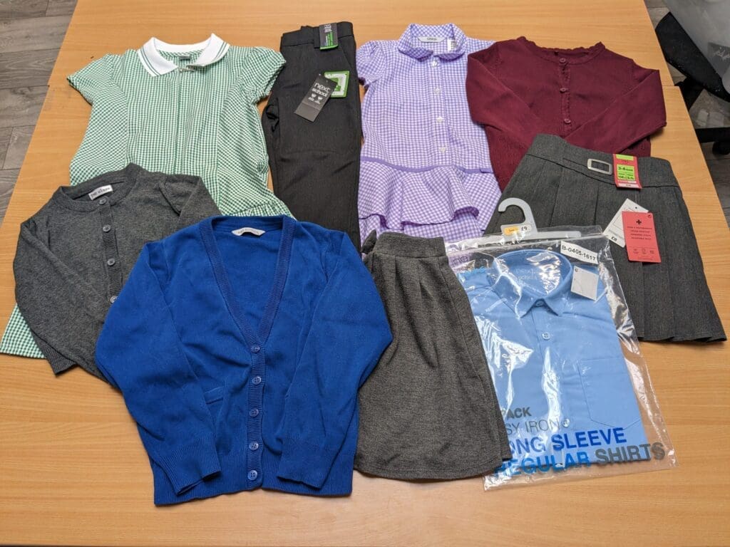 Various jumpers, dresses and shirts folded spread out