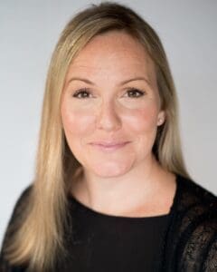 Headshot white woman long straight blond hair black top