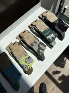 4 pairs of new socks camoflauge colour with animals on shelf