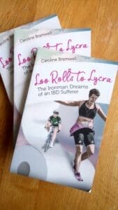 3 copies of the book with Caroline on front in black sports copped top and shorts showing stoma bag