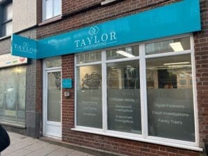 Office front blue sign above three windows