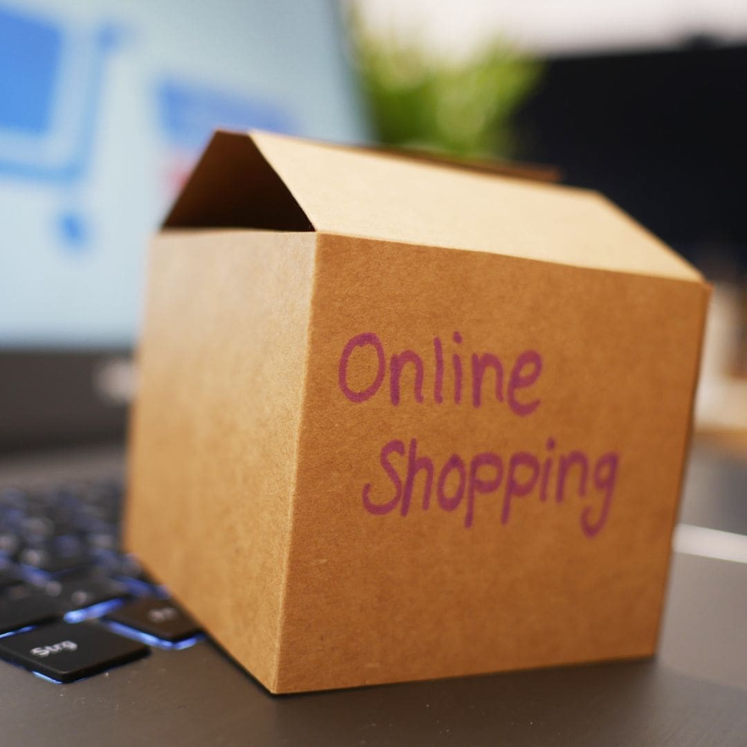 Cardboard box "online shopping" hand written in red on front