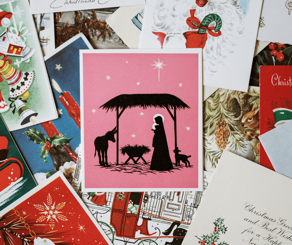 Mixture of Christmas cards pink square card in the middle black silhouette nativity two people crib under straw roof