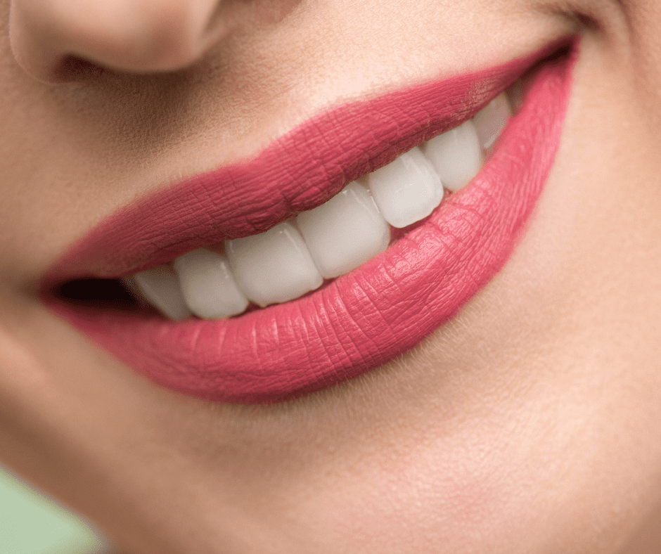 white woman's mouth pink lipstick see top line of teeth smiling