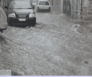 Flooded road black car facing white car away