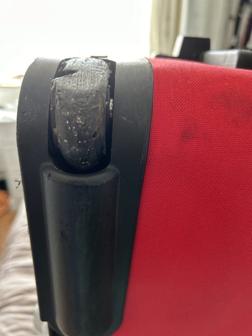 Red case black trim showing damaged wheel