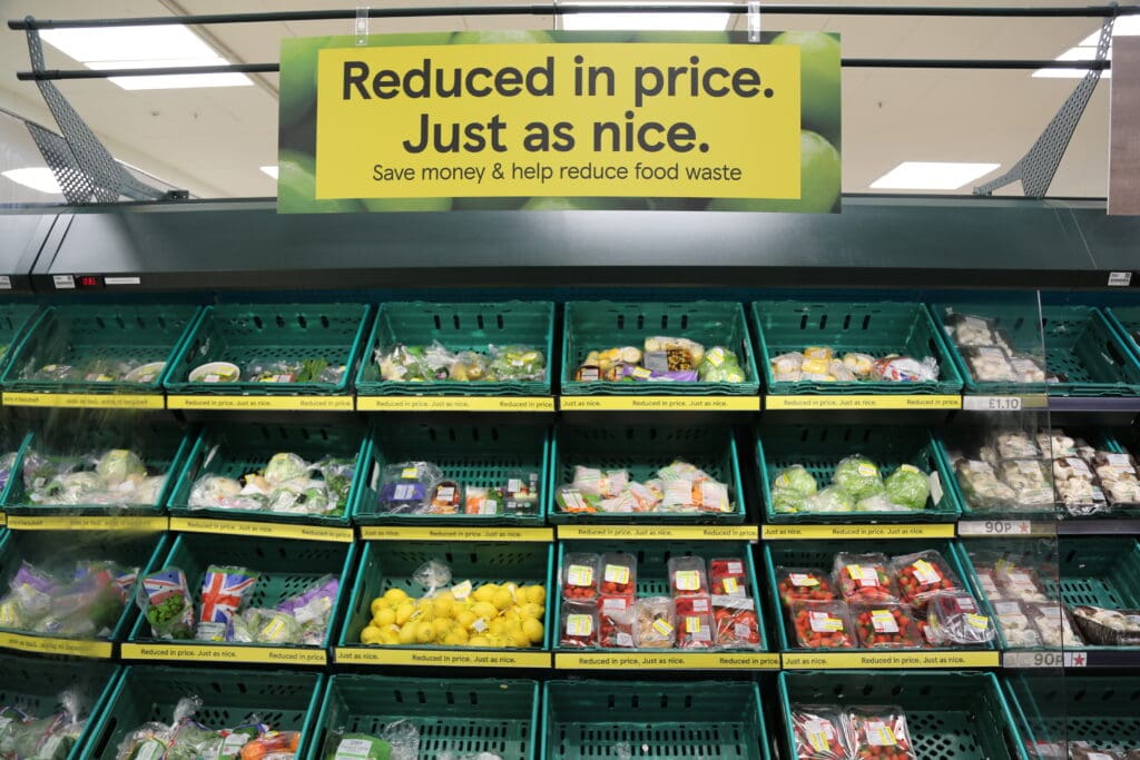 Tesco vegetables with yellow sign above saying "Reduced in price Just as nice"