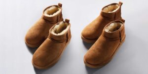 Two pairs of camel coloured Ugg ankle boots looking the same