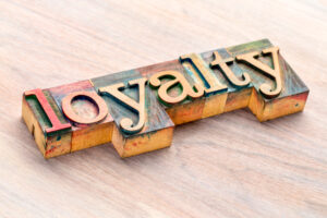 loyalty word abstract in letterpress wood type printing blocks stained by colour inks