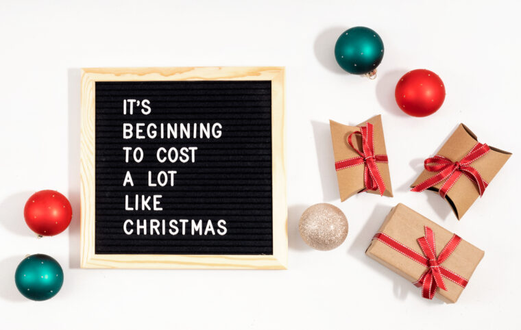 Felt letter board with funny quote text It is beginning to cost a lot like Christmas. Spemding money on expensive xmas gifts concept