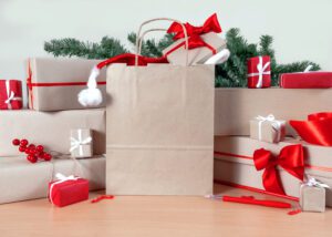Gifts, Shopping bag, Christmas tree and Packing boxes on the table, delivery concept.