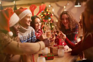 Friends with champagne congratulating each other with xmas