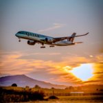 aeroplane in sky evening sun poling through clouds