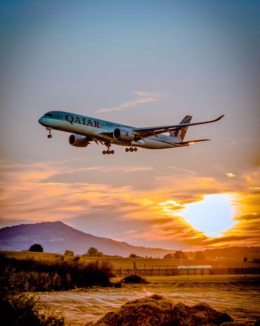 aeroplane in sky evening sun poling through clouds